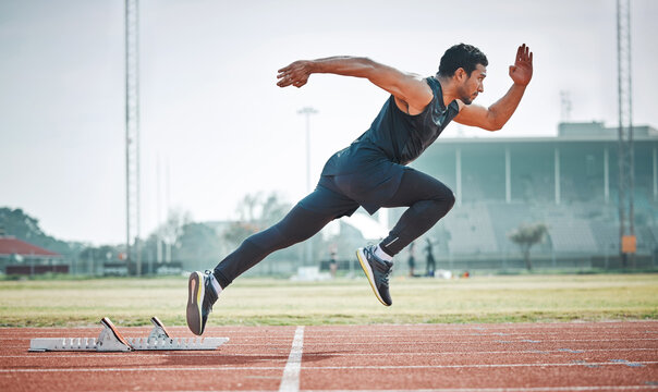 Stadium, man running and athlete on a runner and arena track for sprint race training. Fast, run and sports exercise of a male person in marathon for fitness and workout outdoor on a field for health