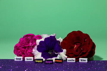 beautiful flowers with nice words in front of them, creative concept spreading positive emotions
