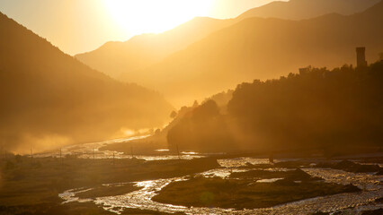 Sunlight in the mountains against the backdrop of a mountain river in Georgia.