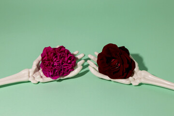 skeleton hands hold flowers, creative romantic concept
