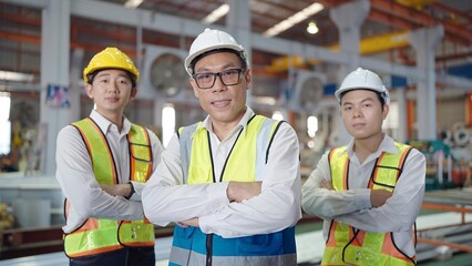 Portrait team of asian engineers men in safety uniform looking at camera while standing with arms...