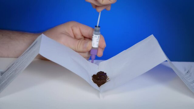 Take sample of faeces with plastic stick and insert it into bottle with extraction solution for home testing