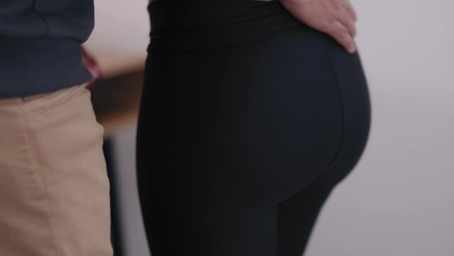 A man caressing his girlfriend's ass romantically 