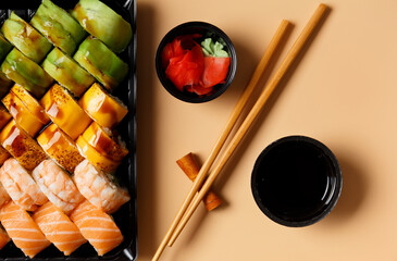 Set of sushi rolls in plastic packages on a light background, top view.