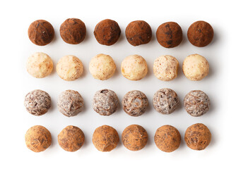 Chocolate candy truffles on white background top view