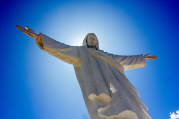 Cristo Blanco (White Jesus) statue with sun halo and blue sky, above Cusco, Peru, South America