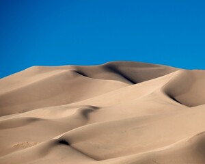 Beautiful view of great dunes under the clear sky during sunrise