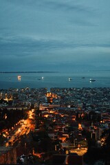 Vertical shot of modern buildings at night in Thessaloniki, Greece