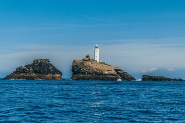 Distant view of the St Ives Lighthouse at the coast of the ocean in England, United Kingdom