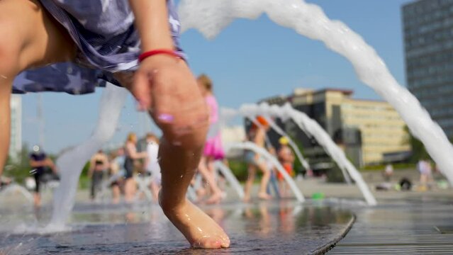 Cute girl playing with a stream of water