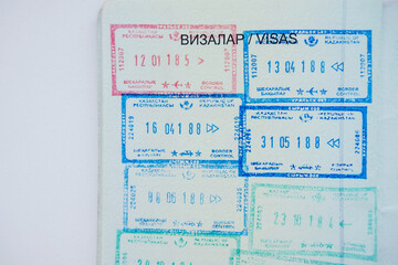 Kazakhstan national passport document for travel. A lot of stamps and visas on it