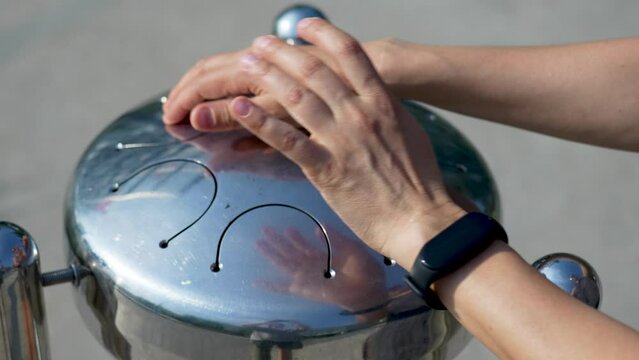 The hands of a musician playing hand drum xylophone