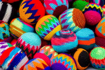 Fototapeta na wymiar Multi-colored/coloured crocheted wool balls, Otavalo, market stall, Ecuador