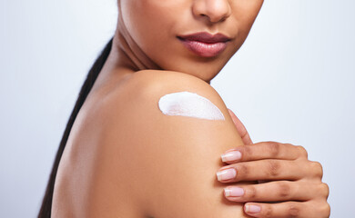 Shoulder, skincare cream and product in studio with hand, moisturiser or sunscreen application by...