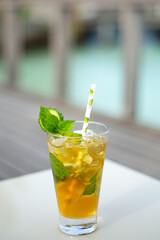 Vertical shot of a fresh cocktail on the white table