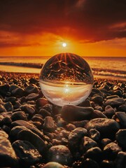 Close up of a crystal ball on a beach during sunset