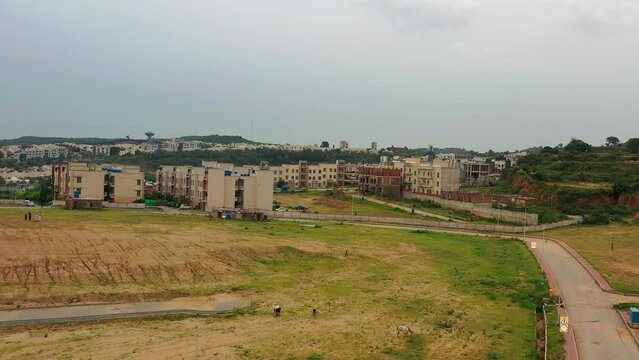 Drone shot showing DHA phase 3 Housing society in Islamabad, Pakistan with gray sky