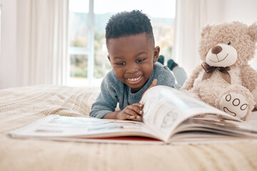 Young african boy, reading and bed for story, book and learning with smile in family home, focus...