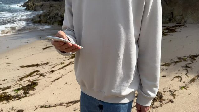 Close up view of male hands using smartphone scrolling, browsing, surfing internet, social media browsing slow motion