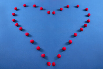 Heart, pattern and tennis ball on a floor for fitness, health lifestyle and cardiovascular exercise in empty studio. Red, balls and sports equipment in frame for cardio wellness, message and workout