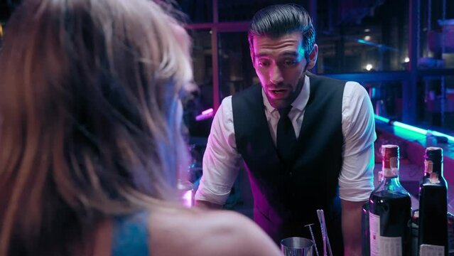 Bartender man take order with Ladies clients at  in nightclub bar in restaurant