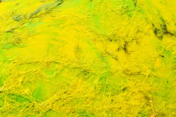 Multicolored creative abstract background. Texture of acrylic paint. Stains and blots of alcohol ink yellow colors, fluid art.