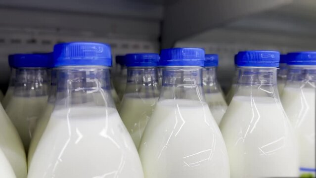 milk in plastic bottles on the supermarket shelves. healthy eating protein cow milk concept. dairy products on store shelves. dairy products in plastic on store shelves lifestyle