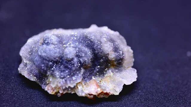 Macro shot of chalcedony mineral from Brazil on purple background