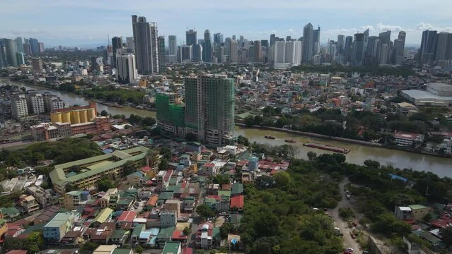 Aerial of crowded residential buildings in the center near Pasig River in the Philippines