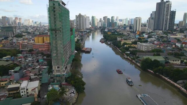 Aerial view of Pasig river with high and modern buildings in the background in Philippines