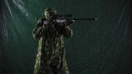 military paratrooper with a sniper rifle on a green background