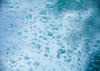 water drops on the glass are blue. abstract photography