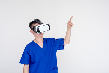 A young and concentrated medical student or nurse or intern pointing while wearing VR glasses. Isolated on a white background.