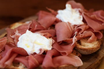 Traditional Matera Basilicata Italy antipasti starter - cured prosciutto crudo lucano, bruschetta and mozzarella di buffalo cheese