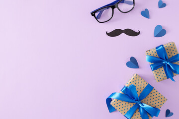 Happy Father's Day concept. Top view flat lay of gift boxes with ribbon, eyeglasses, mustache and blue hearts on lilac background with empty space for text or greeting message