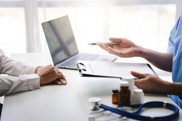 Doctor talking to patient and filling patient history, examination, treatment, medical and health...