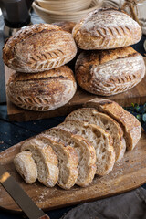 Artisan Batard Sourdough healthy Bread with leaf scoring. Open crumb high hydration Sourdough bread set on white table. - 606024053