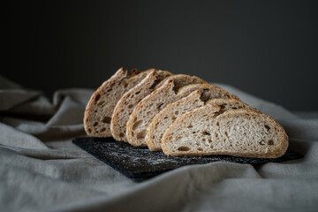 Artisan Batard Sourdough healthy Bread. Open crumb high hydration Sourdough french country bread set on dark background. - 606024058