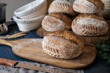 Artisan Batard Sourdough healthy Bread with leaf scoring. Open crumb high hydration Sourdough bread set on white table. - 606024059