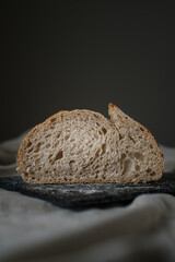Artisan Batard Sourdough healthy Bread. Open crumb high hydration Sourdough french country bread set on dark background. - 606024060