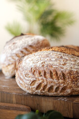 Artisan Batard Sourdough healthy Bread with leaf scoring. Open crumb high hydration Sourdough bread set on white table. - 606024061