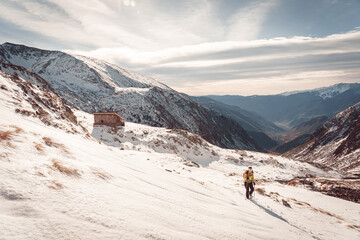 Fototapeta na wymiar Mountaineer girl in snowy mountains