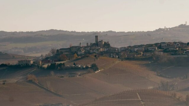 a 4k video of the castle of Serralunga d'alba and its hills full of vineyards, typical of the Piedmontese Langhe. in the winter of 2023