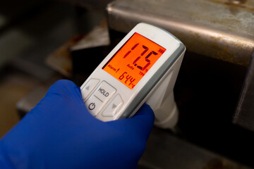 Fryer oil tester. Checking the level of carcinogenic in the oil industrial production. The red...
