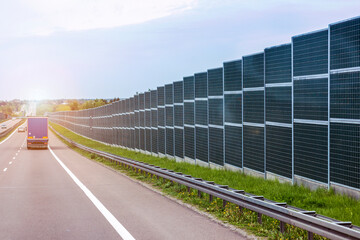 Road Noise Barrier Wall with Truck on Highway. Traffic Noise Protection.