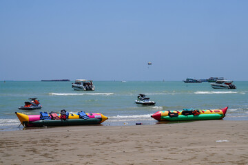 Fototapeta premium Atmosphere of North Pattaya Beach of Pattaya City, Chonburi Province, Thailand, with rides and boats waiting for tourists, taken on 18 May 2023.