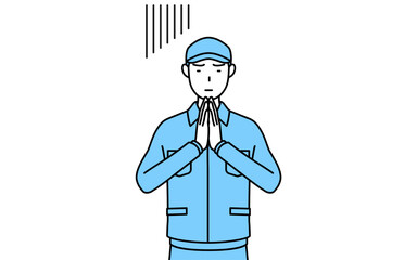 体の前で手を合わせて謝る帽子と作業着姿の男性