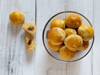 Nastar Cookies, Pineapple tarts or nanas tart are small, bite-size pastries filled with pineapple jam, popular  during Eid Al Fitr or Lebaran. Served in clear bowl. 