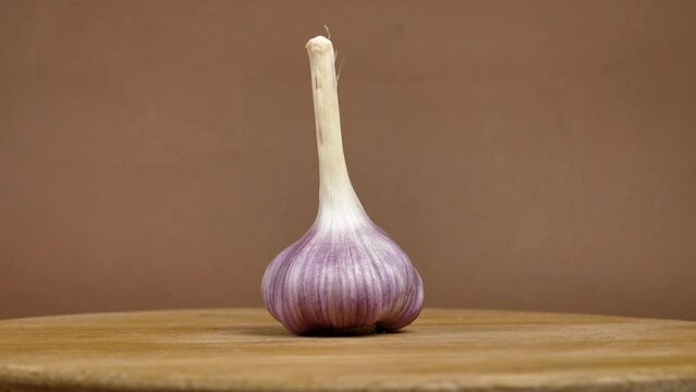 rotating young garlic on brown background