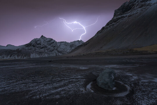 Amazing view of snowy mountains with plains and lightning